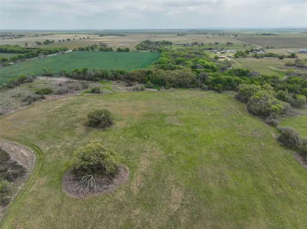 a view of a field with an ocean