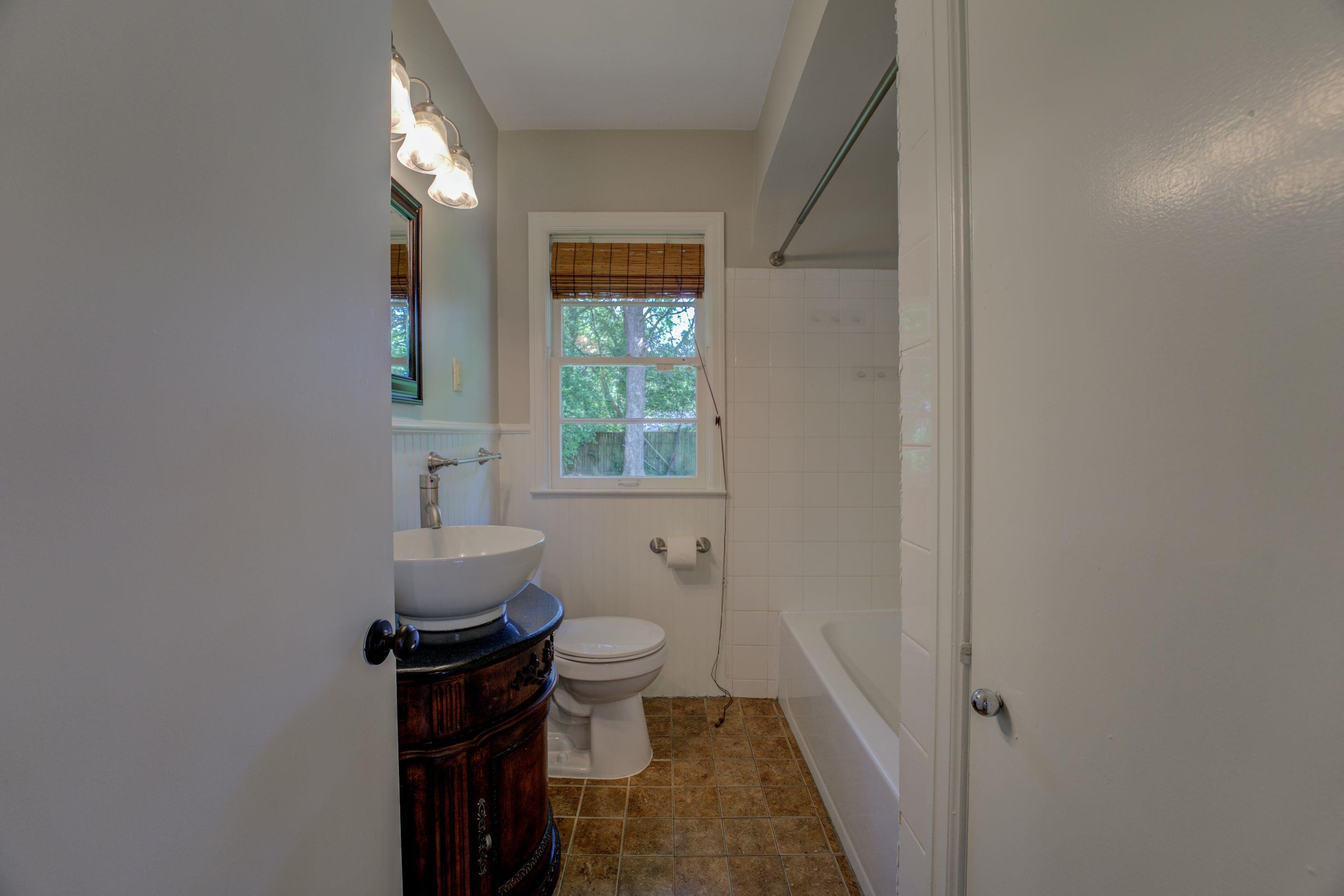 4708 Chip Road Memphis, TN 38117 - Photo 7 of 21 a bathroom with a toilet sink and mirror