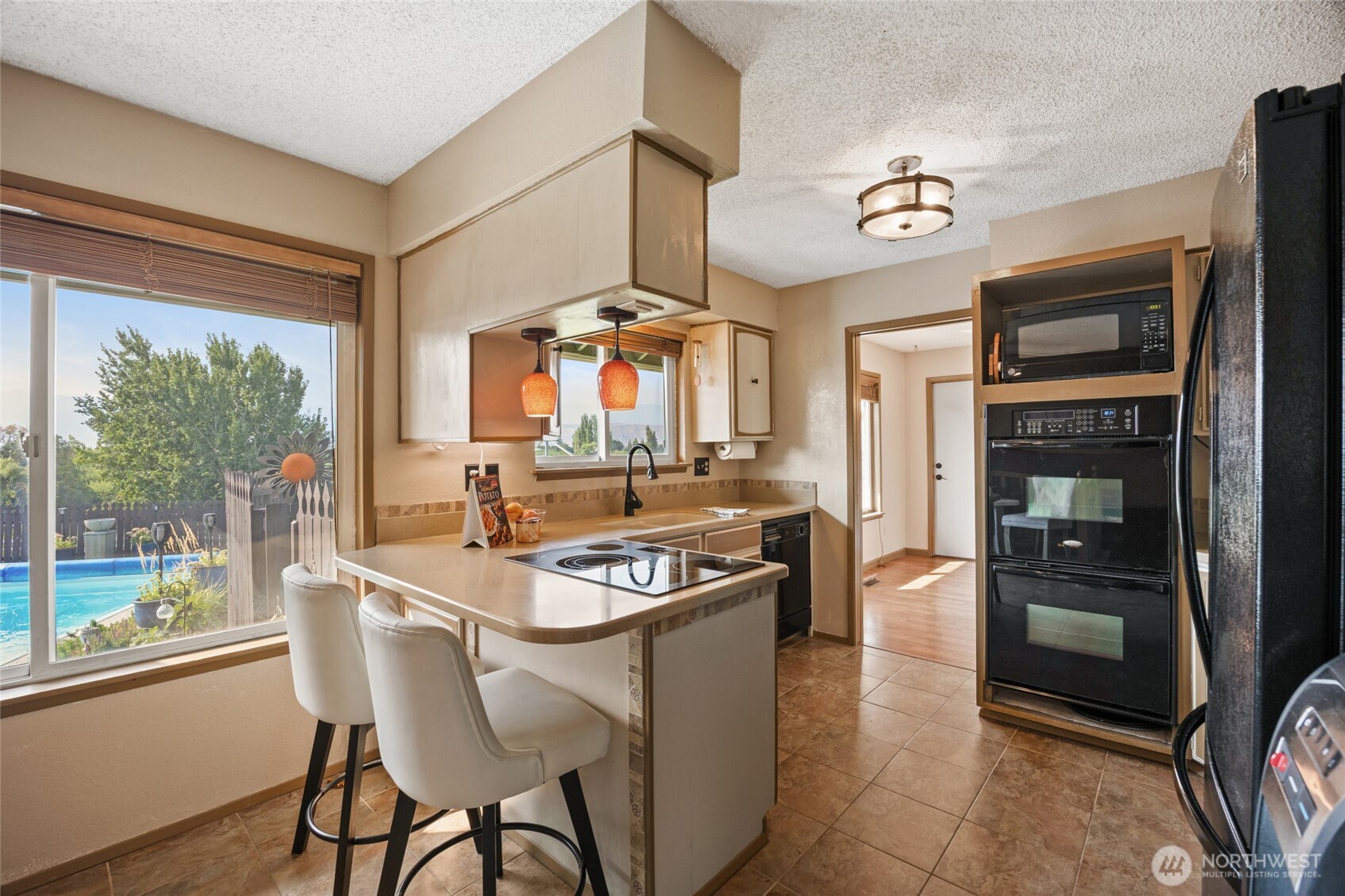 2716 8th Street Northeast East Wenatchee, WA 98802 - Photo 14 of 40 a kitchen with a stove a refrigerator and a stove top oven