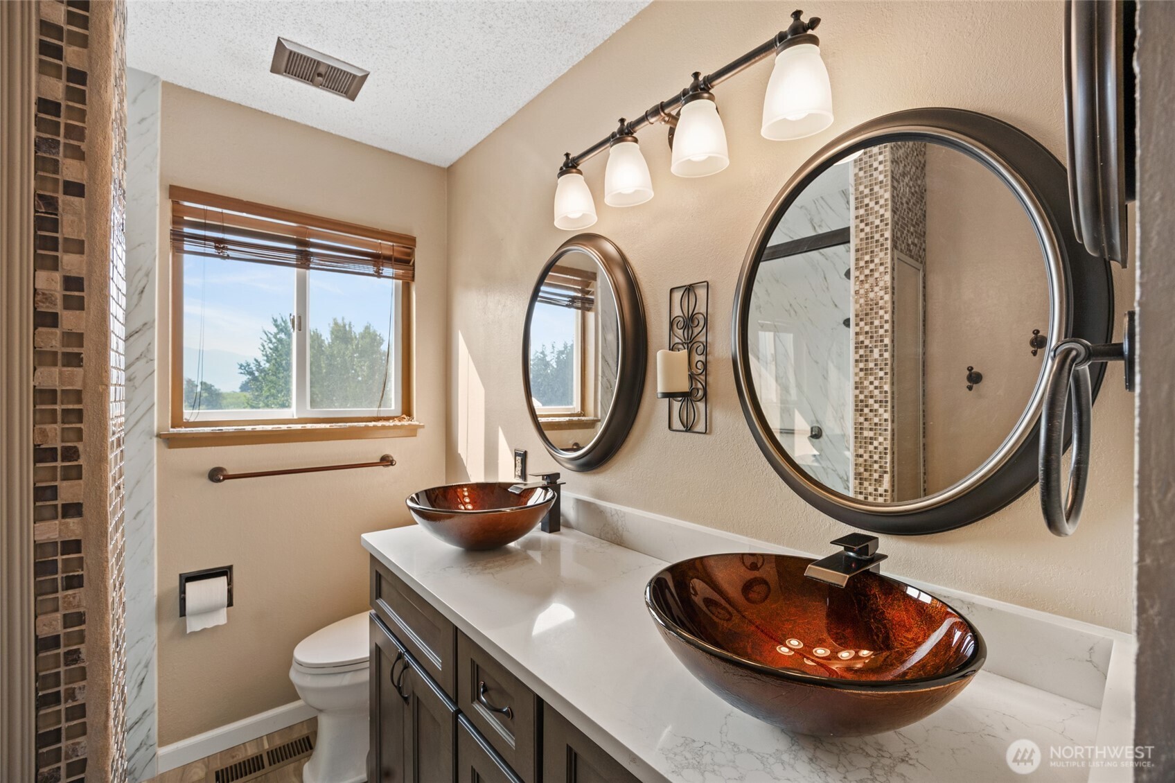 2716 8th Street Northeast East Wenatchee, WA 98802 - Photo 17 of 40 a bathroom with a sink a mirror and a toilet