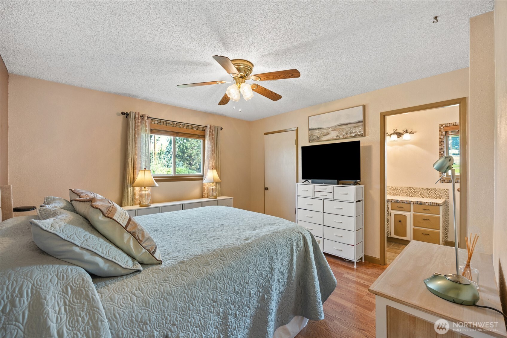 2716 8th Street Northeast East Wenatchee, WA 98802 - Photo 18 of 40 a bedroom with a bed and a flat screen tv