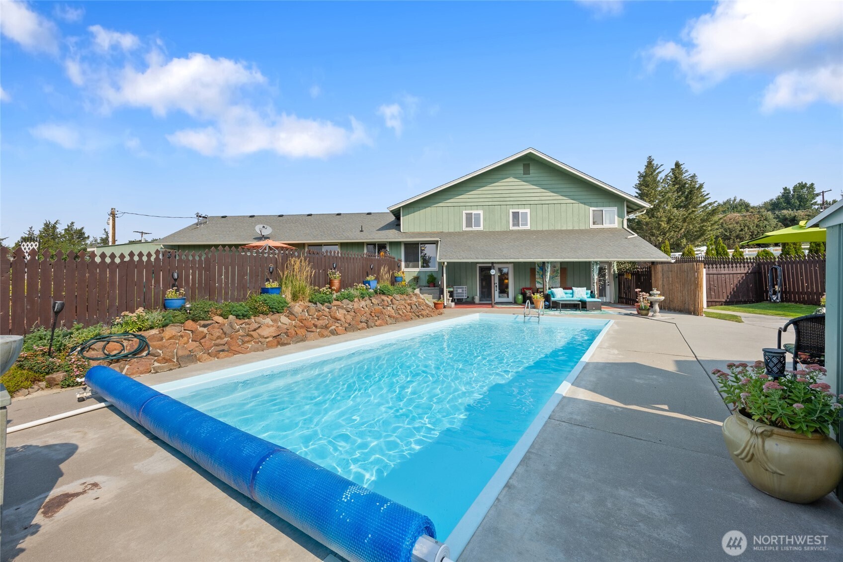 2716 8th Street Northeast East Wenatchee, WA 98802 - Photo 29 of 40 a view of a house with swimming pool and furniture