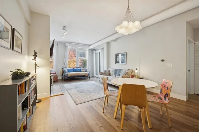 a living room with furniture and a chandelier