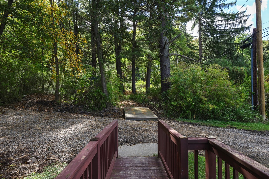 5 Powderhouse Road Corning, NY 14830 - Photo 35 of 47 Mature trees frame the gravel driveway and wooden