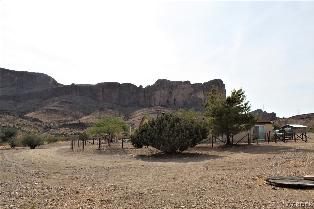1950 Growler Road Golden Valley, AZ 86413 - Photo 21 of 42 a view of a dry yard with trees