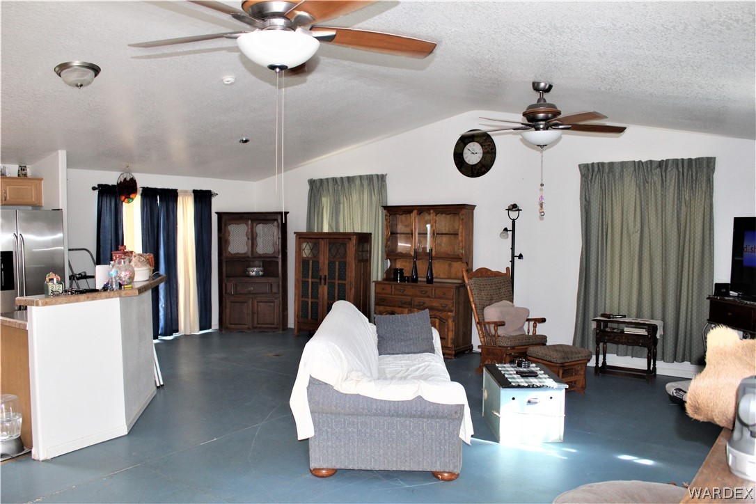 1950 Growler Road Golden Valley, AZ 86413 - Photo 26 of 42 a living room with furniture and a clock