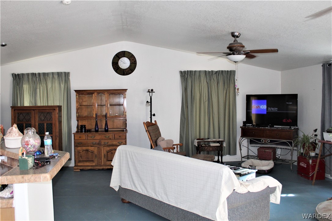 1950 Growler Road Golden Valley, AZ 86413 - Photo 29 of 42 a living room with furniture and a flat screen tv
