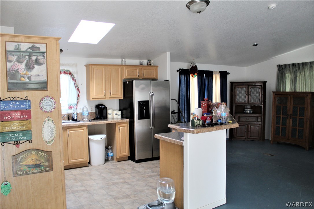 1950 Growler Road Golden Valley, AZ 86413 - Photo 30 of 42 a kitchen with refrigerator and cabinets