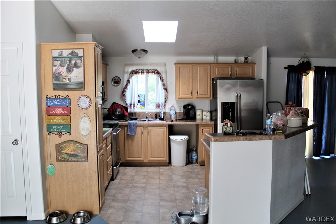 1950 Growler Road Golden Valley, AZ 86413 - Photo 31 of 42 a kitchen with refrigerator and window