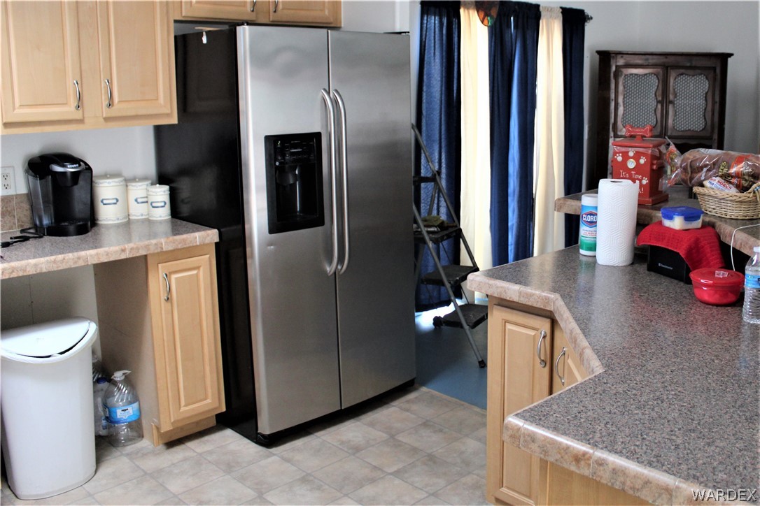 1950 Growler Road Golden Valley, AZ 86413 - Photo 33 of 42 a kitchen with stainless steel appliances granite countertop a refrigerator and a sink