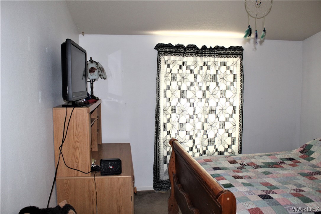 1950 Growler Road Golden Valley, AZ 86413 - Photo 35 of 42 a bedroom with a bed and a window