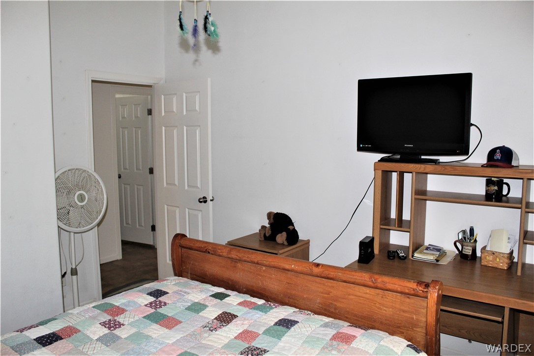 1950 Growler Road Golden Valley, AZ 86413 - Photo 36 of 42 a bedroom with a bed and a flat screen tv