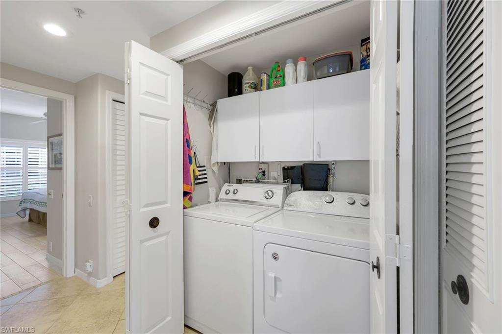 13201 Sherburne Circle, Unit 102 Bonita Springs, FL 34135 - Photo 13 of 22 a utility room with dryer and washer