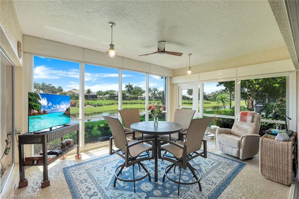13201 Sherburne Circle, Unit 102 Bonita Springs, FL 34135 - Photo 14 of 22 a view of a dining room with furniture large windows and wooden floor