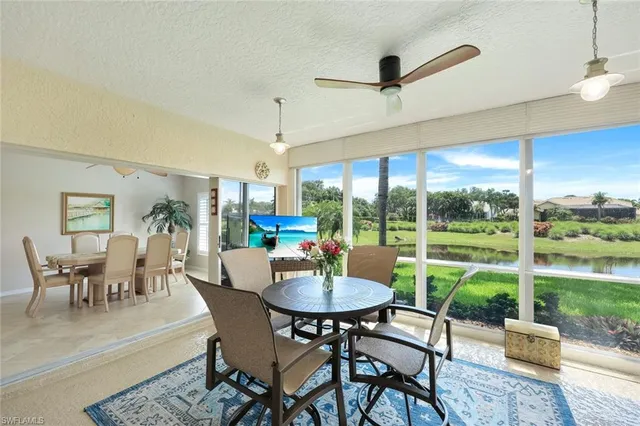 a view of a dining room with furniture large windows and wooden floor