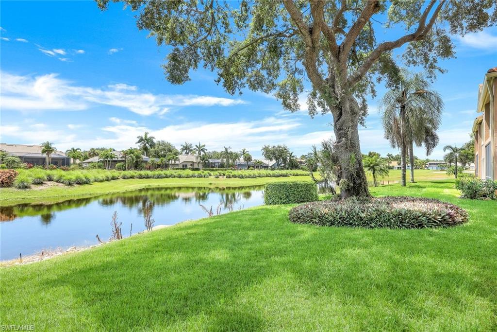 13201 Sherburne Circle, Unit 102 Bonita Springs, FL 34135 - Photo 16 of 22 a view of a lake with houses in the background