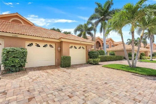 a view of a lake with houses in the background