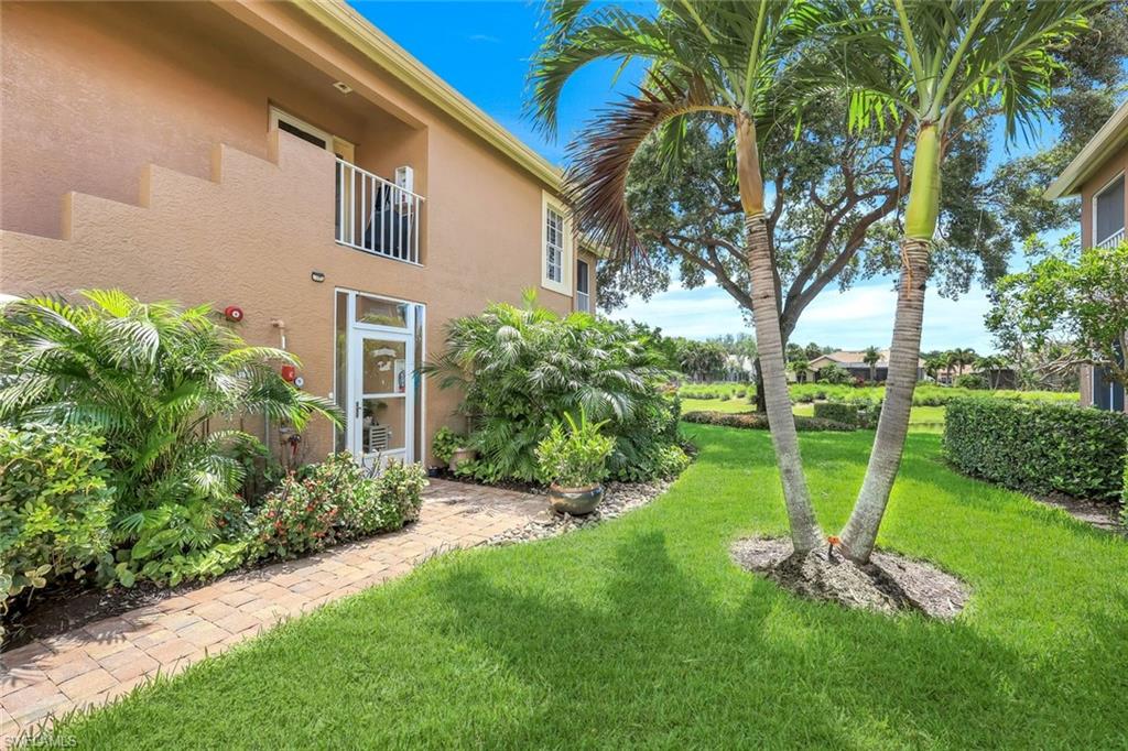 13201 Sherburne Circle, Unit 102 Bonita Springs, FL 34135 - Photo 18 of 22 a view of a backyard with plants and a large tree