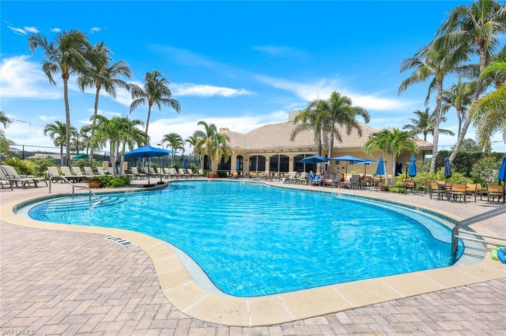 13201 Sherburne Circle, Unit 102 Bonita Springs, FL 34135 - Photo 20 of 22 a swimming pool with outdoor seating and yard