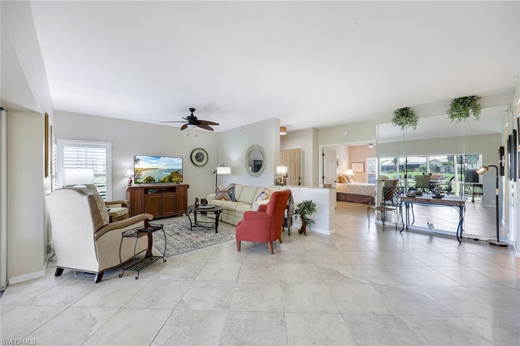 13201 Sherburne Circle, Unit 102 Bonita Springs, FL 34135 - Photo 3 of 22 a living room with furniture and kitchen view