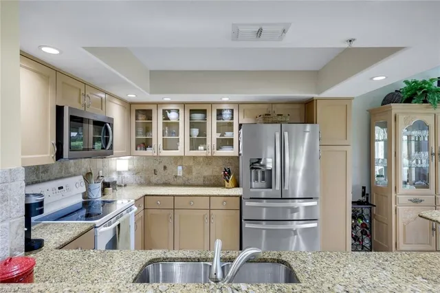 a kitchen with sink and cabinets