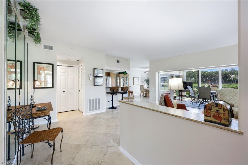 13201 Sherburne Circle, Unit 102 Bonita Springs, FL 34135 - Photo 7 of 22 a living room with furniture and a large window