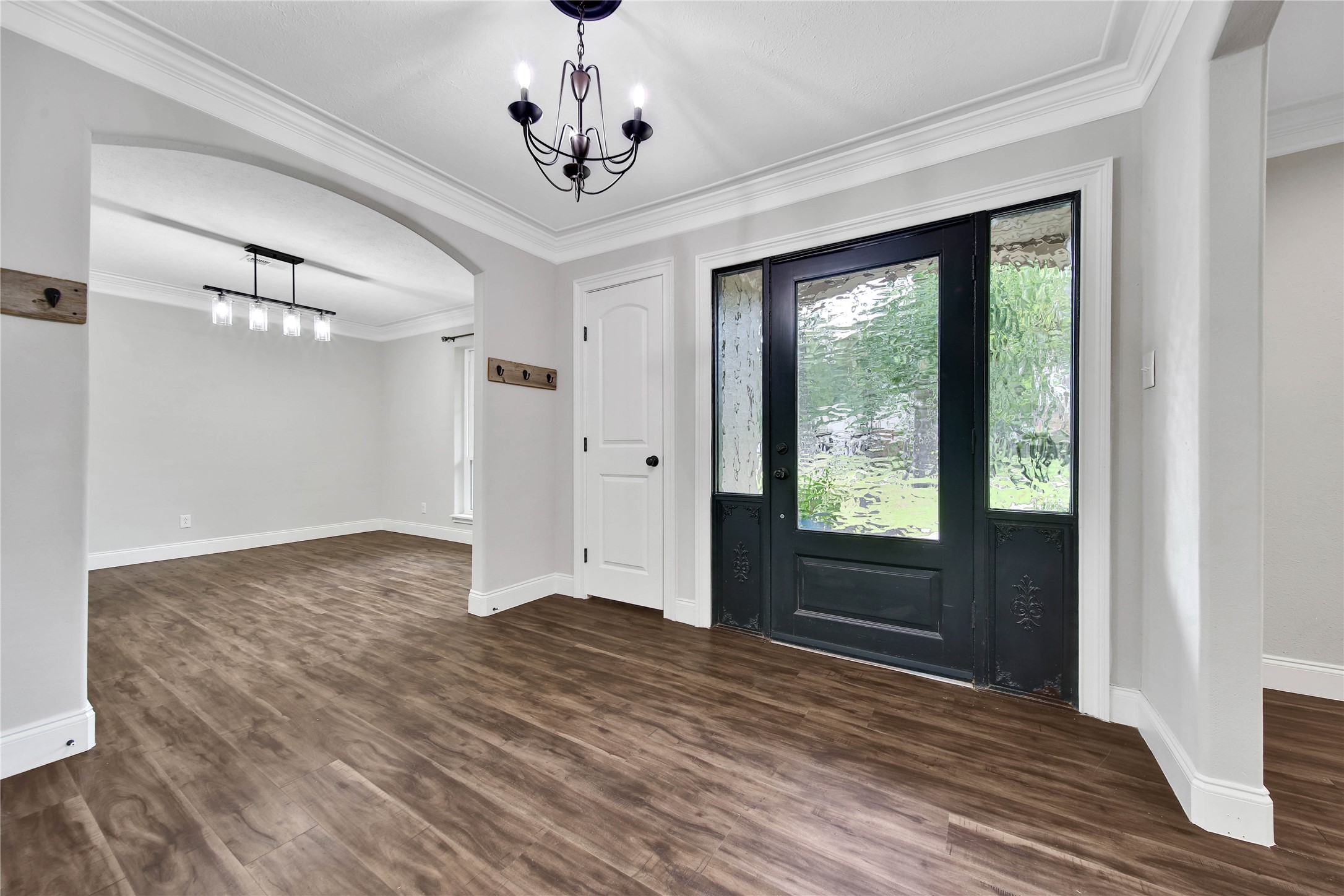 6407 Craigway Road Spring, TX 77389 - Photo 3 of 47 Inviting foyer welcomes you into the home with wood-look luxury vinyl tile flooring extending throughout the first floor. The open sightlines create a warm and inviting first impression. Bonus feature: two storage/coat closets!