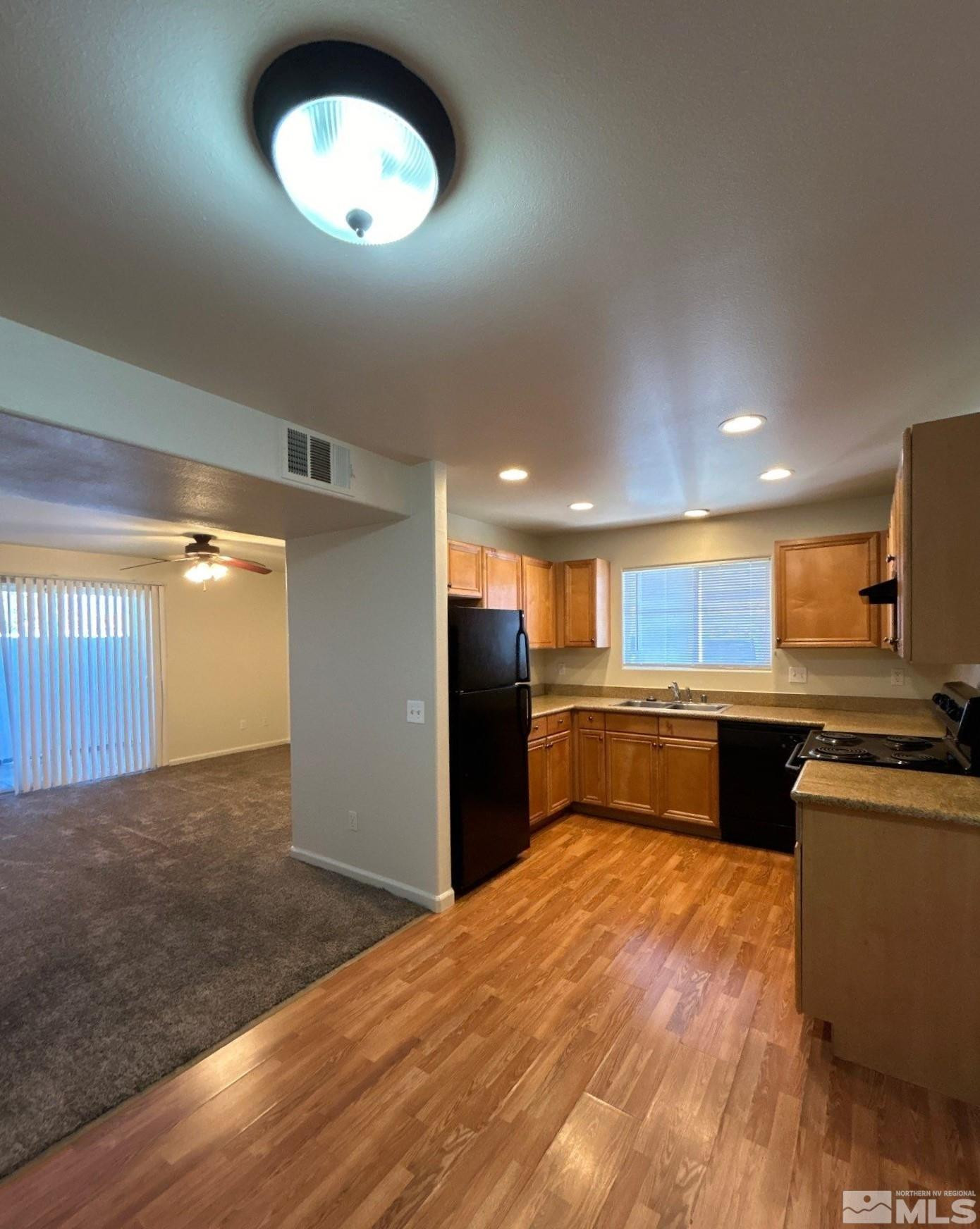 2000 Silverada Boulevard, Unit 112 Reno, NV 89512 - Photo 5 of 19 a view of kitchen with refrigerator microwave and stove