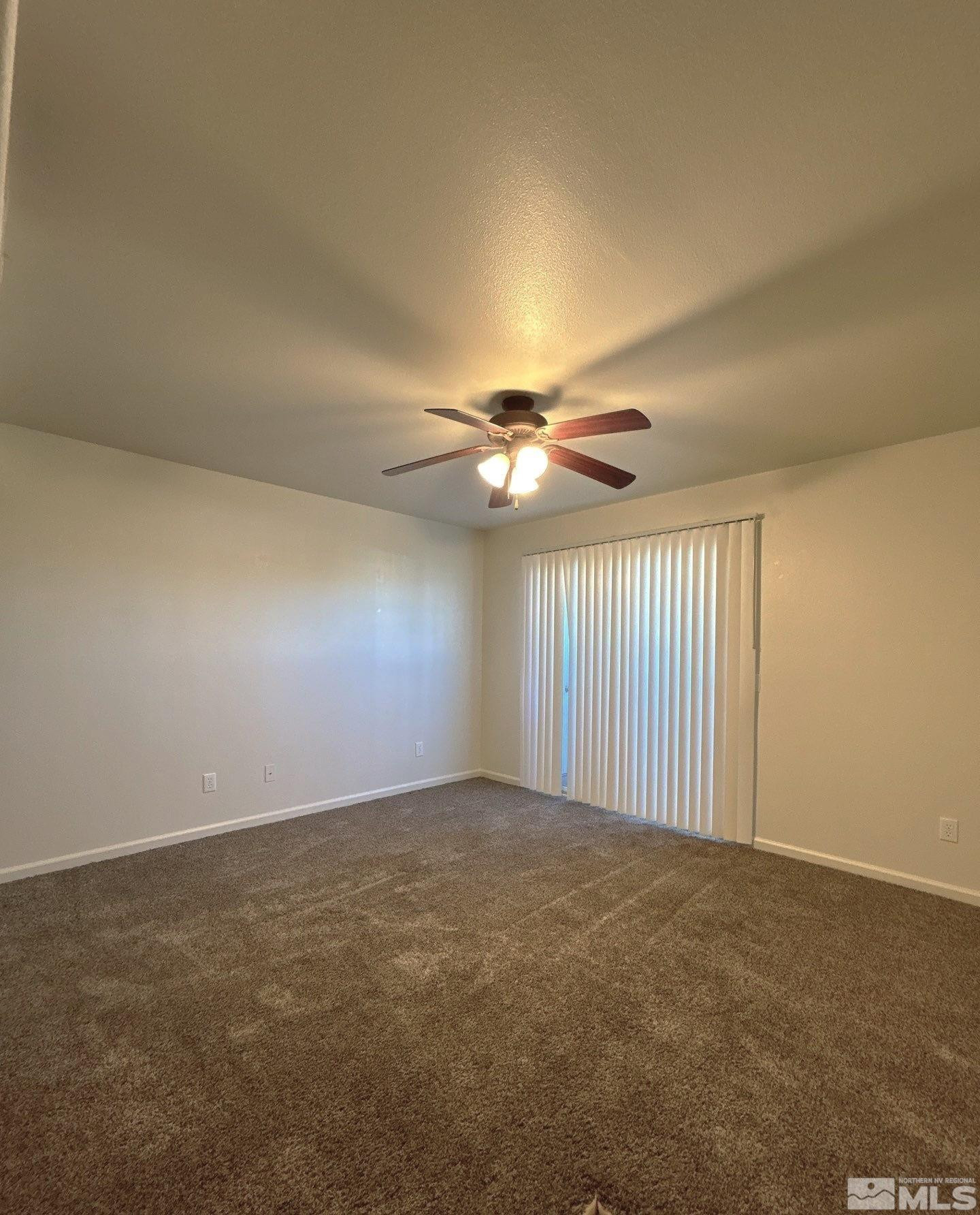 2000 Silverada Boulevard, Unit 112 Reno, NV 89512 - Photo 8 of 19 an empty room with windows and fan chandelier fan