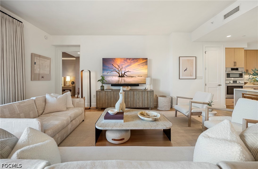 1115 Central Avenue, Unit 443 Naples, FL 34102 - Photo 11 of 40 a living room with furniture and a flat screen tv