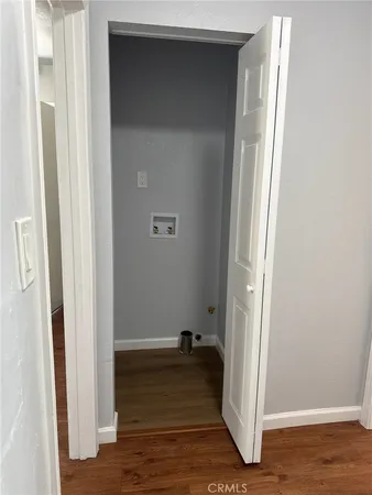 a view of a livingroom with wooden floor and closet