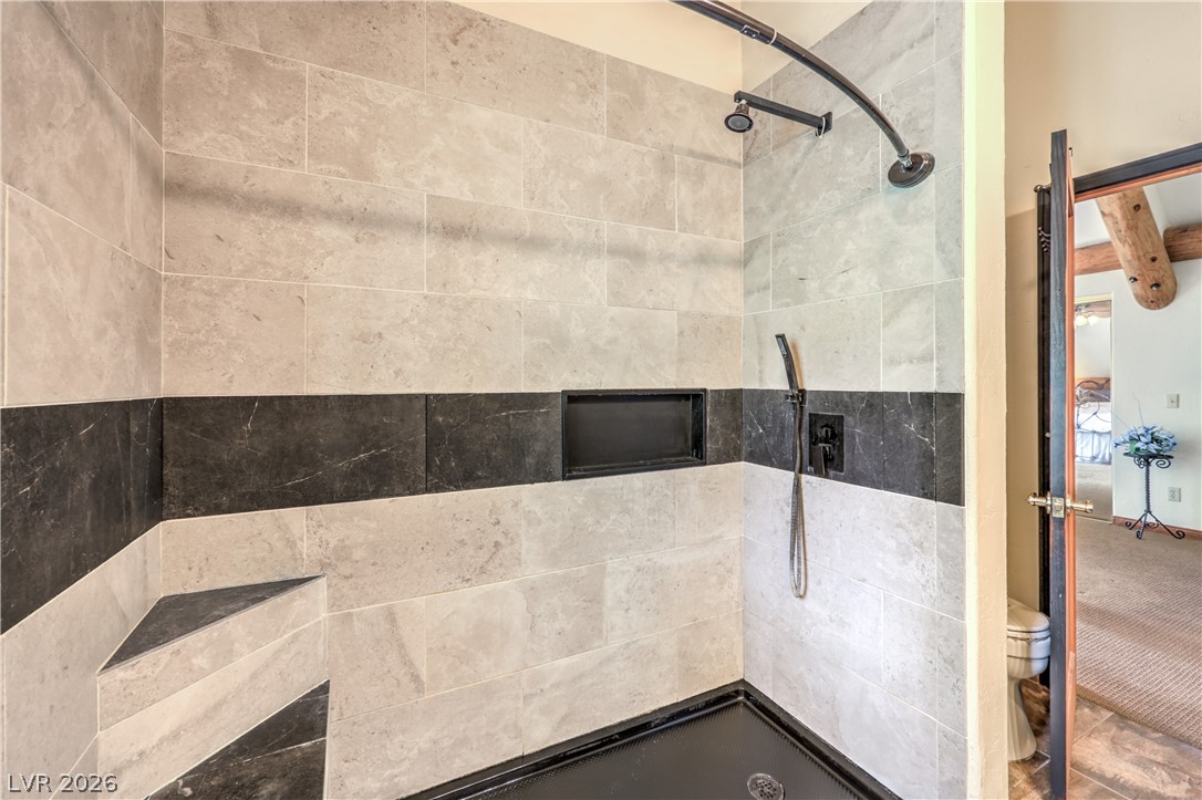 322 Ski Trail Road Mount Charleston, NV 89124 - Photo 24 of 58 Fine tilework and custom stone accents define this modern walk-in shower design.