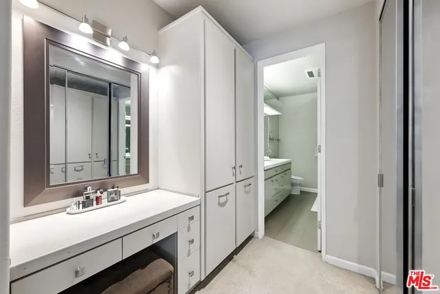 a bathroom with a double vanity sink mirror and cabinets