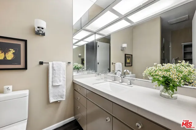 a bathroom with a sink a vanity and a mirror