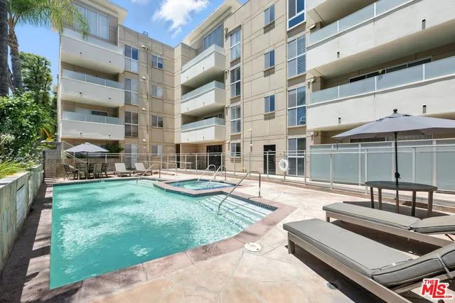 a view of a swimming pool with chairs in patio