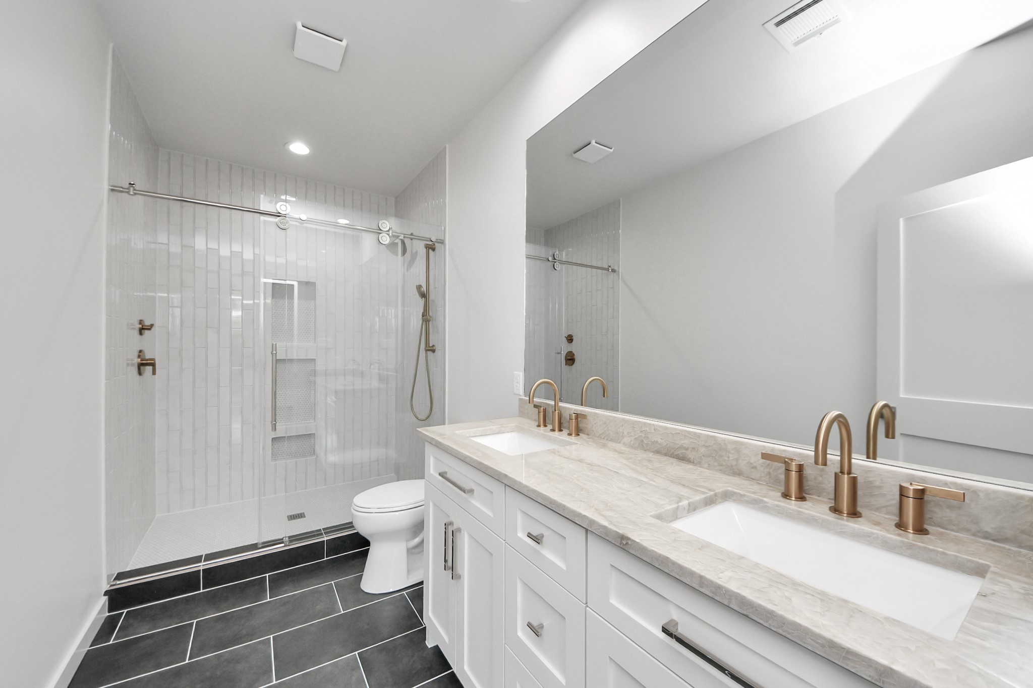 4541 Walker Street Houston, TX 77023 - Photo 19 of 24 a bathroom with a double vanity sink toilet and shower