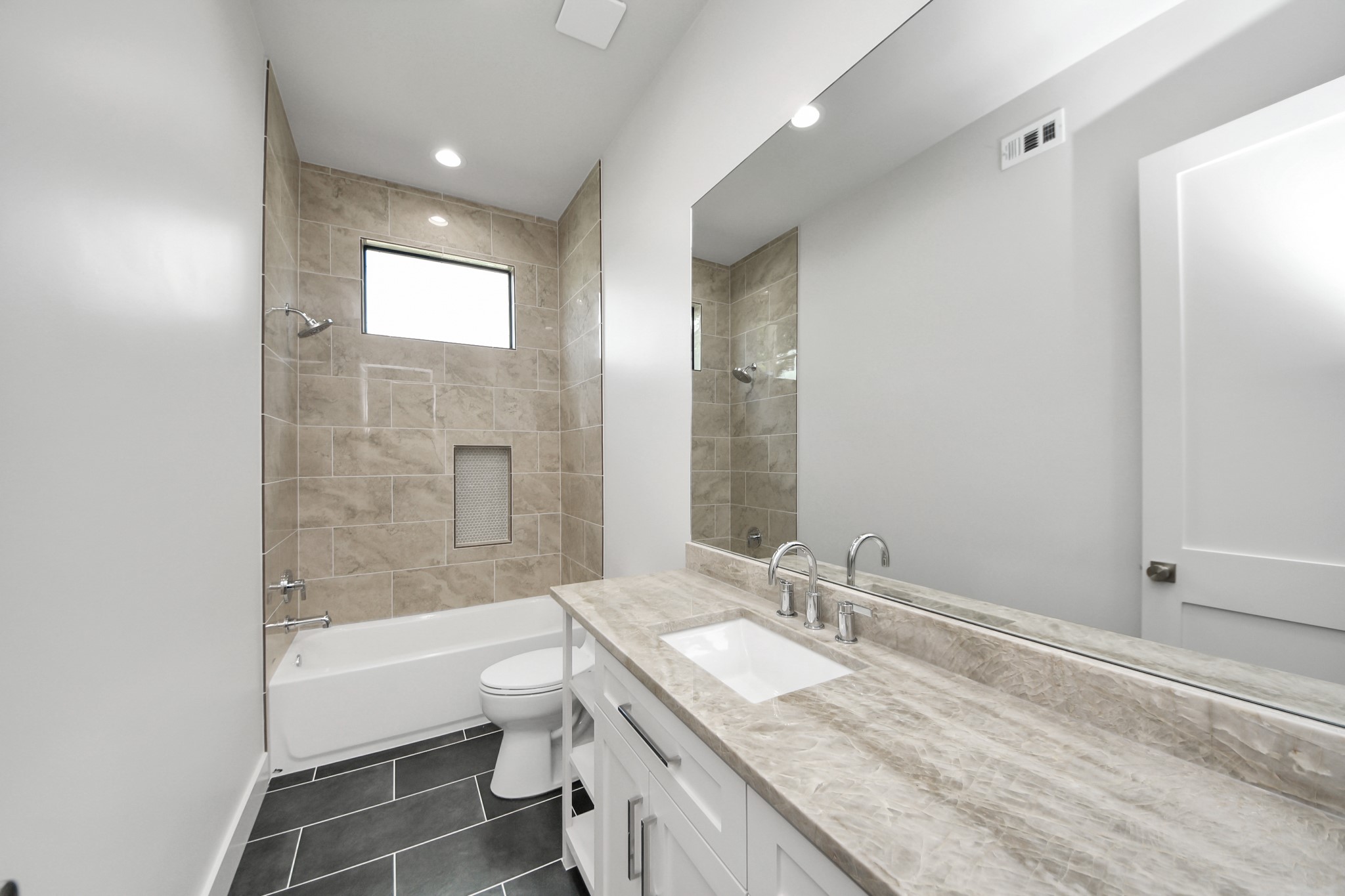 4541 Walker Street Houston, TX 77023 - Photo 21 of 24 a bathroom with a granite countertop sink a toilet and shower