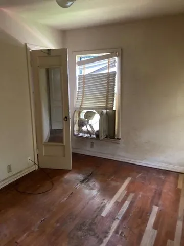 a view of a livingroom with wooden floor and a window