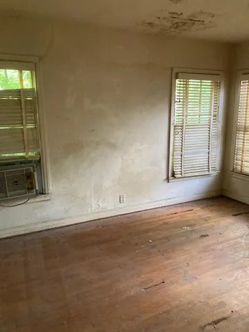an empty room with a empty space and windows