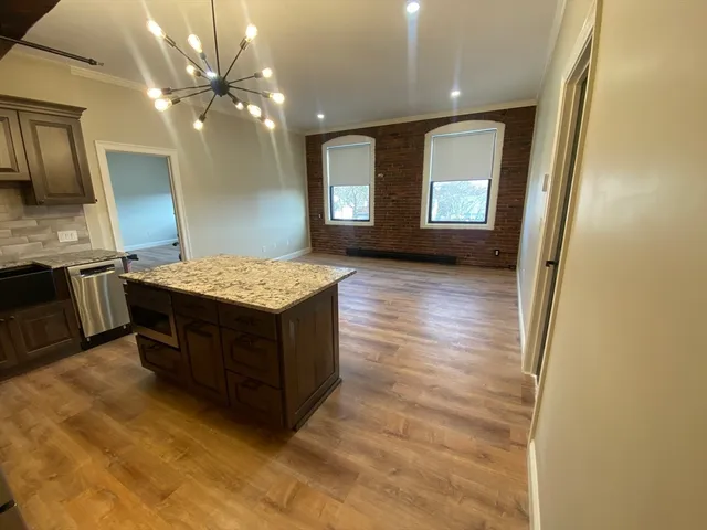 a spacious bathroom with a granite countertop sink and a mirror