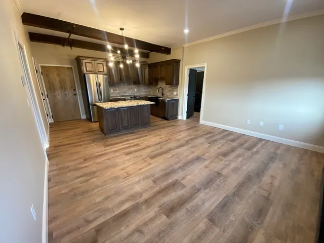 a view of a refrigerator in kitchen and a sink