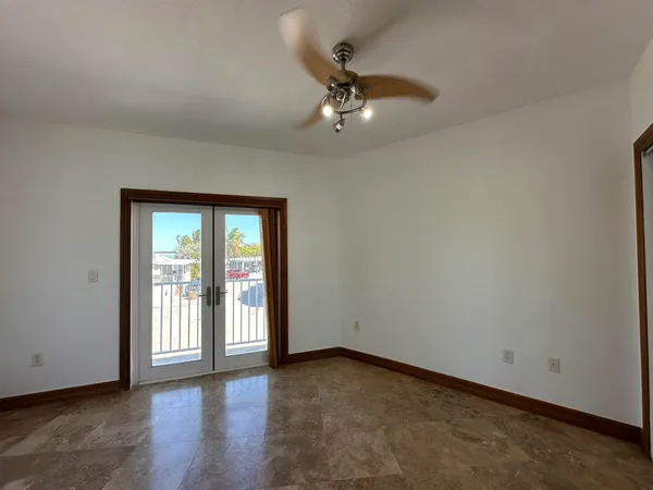 a utility room with furniture a flat screen tv and a couch