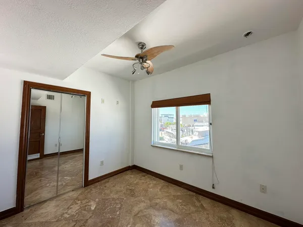 a bathroom with a granite countertop sink a mirror a toilet a mirror and shower