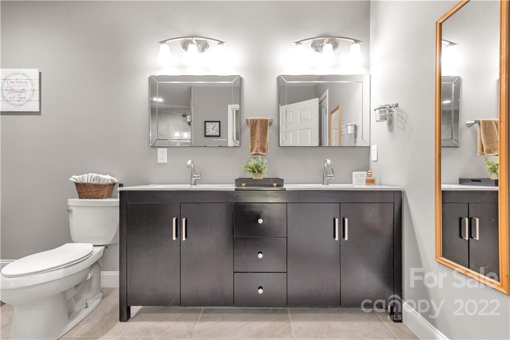 2098 Beamguard Road Clover, SC 29710 - Photo 20 of 36 a bathroom with a granite countertop sink a toilet and mirror