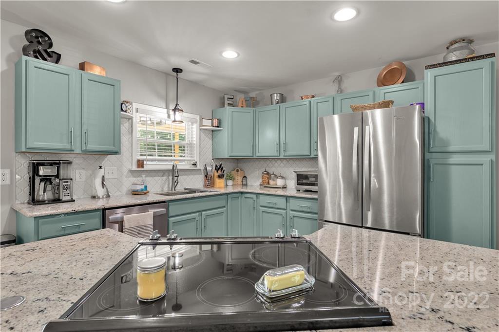 2098 Beamguard Road Clover, SC 29710 - Photo 9 of 36 a kitchen with stainless steel appliances granite countertop a sink refrigerator and microwave