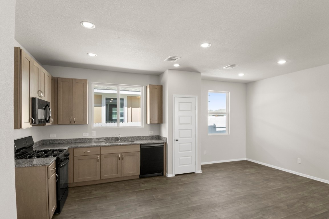 167 Daylily Drive Elgin, TX 78621 - Photo 17 of 29 a kitchen with a sink stove and cabinets