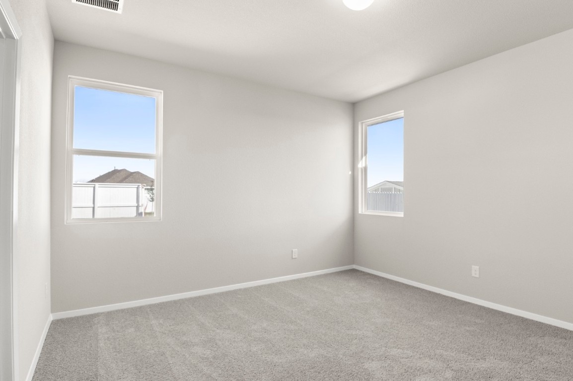 167 Daylily Drive Elgin, TX 78621 - Photo 21 of 29 an empty room with windows