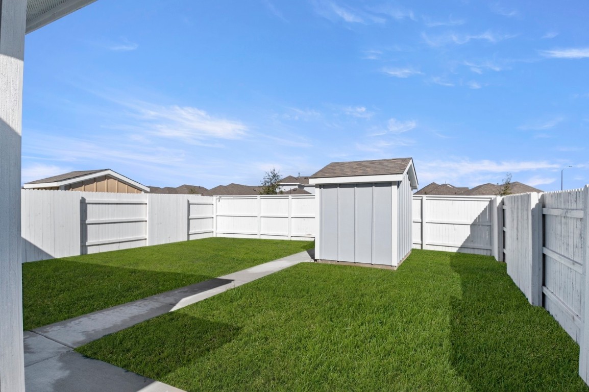 167 Daylily Drive Elgin, TX 78621 - Photo 28 of 29 a view of a house with backyard and garden