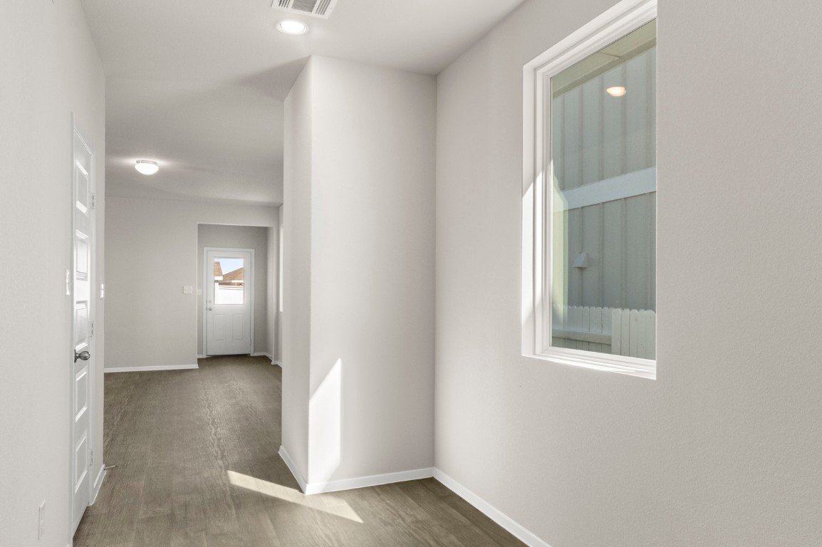 167 Daylily Drive Elgin, TX 78621 - Photo 6 of 29 an empty room with windows and entrance