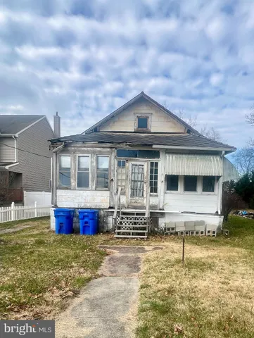 a front view of house with yard space and balcony
